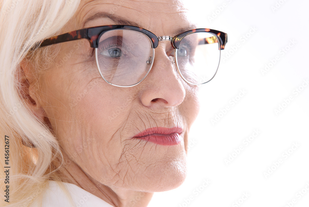 Pensive glancing old female person Pensive glancing old female person