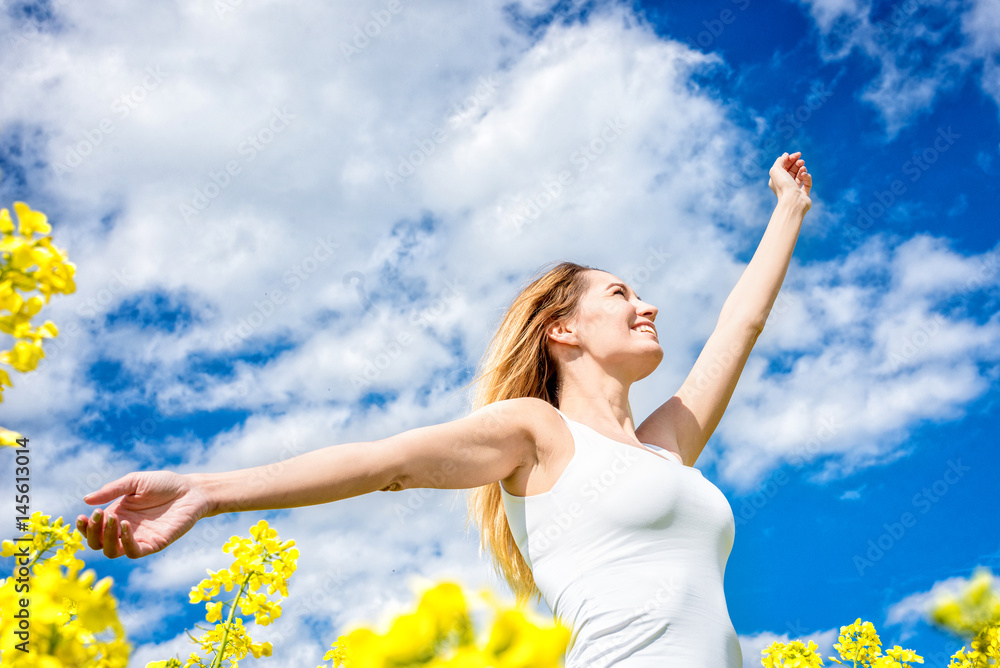 Carefree woman in rapeseed field Carefree woman in rapeseed field