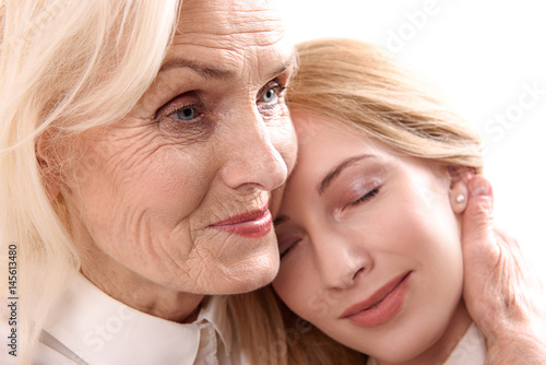 Glance of happy woman necking her daughter