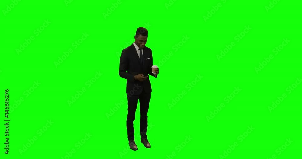 Businessman using mobile phone while having coffee Businessman using mobile phone while having coffee