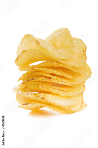 stack of crispy potato chips isolated on white background close-up