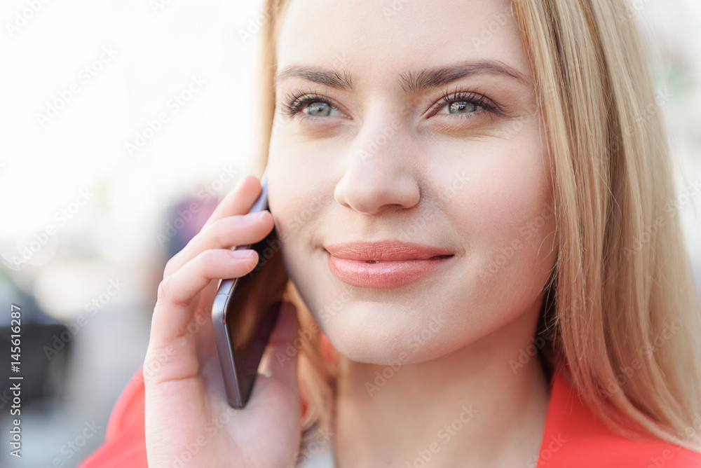 Dreamful woman chatting on mobile phone Dreamful woman chatting on mobile phone