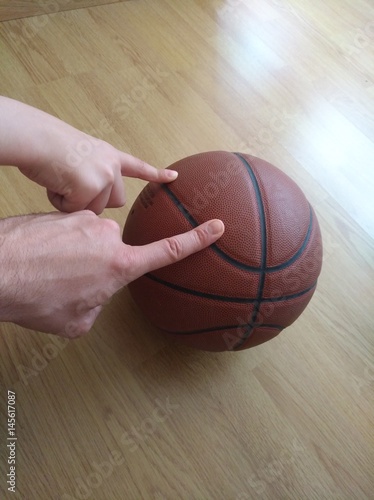 Dedos señalando balón de baloncesto