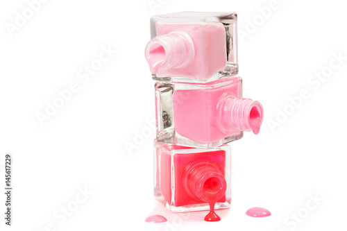 Stack of pink nail polish isolated on white background