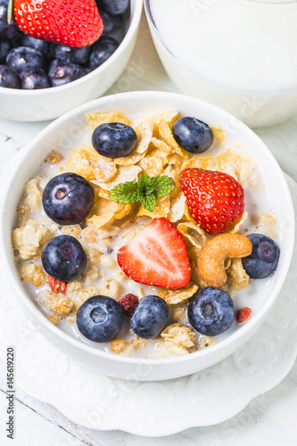 crunchy flakes with blueberries and various yogurts for healthy breakfast