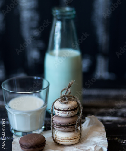 Colorful macaroons on dark wooden background. Sweet macarons. 