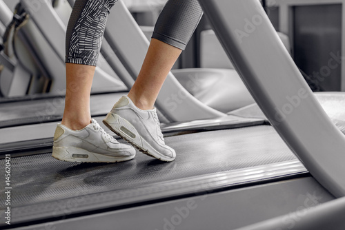 Legs of woman running on treadmill