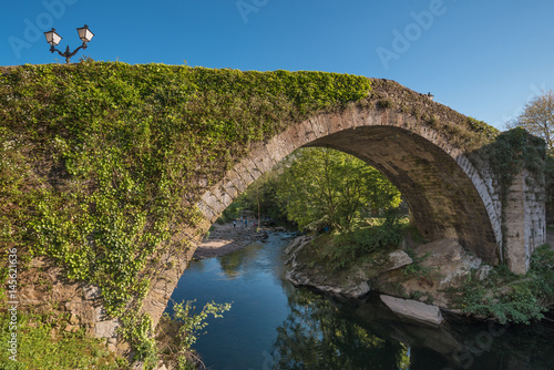 Medieval bridge over Miera river in Lierganes, Cantabria, Spain. photo