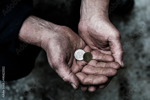In the hands of man are different metal coins.
 photo