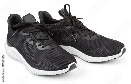 Pair of new unbranded black sport running shoes, sneakers or trainers isolated on white background with clipping path