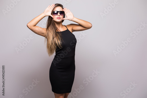 Portrait of Fashion portrait of young beautiful woman in the black dress on grey © F8  \ Suport Ukraine