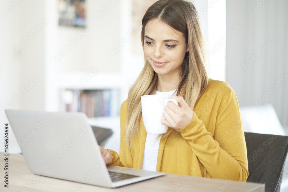 Home office. Shot of a young thinking woman sitting in front of laptop and working online. Home office. Shot of a young thinking woman sitting in front of laptop and working online.