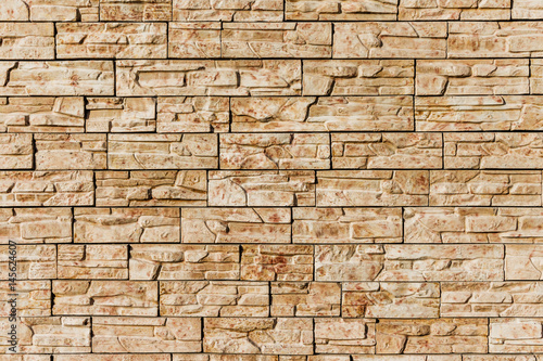 Seamless texture, background, stone lined with granite walls. Sandstone. Stone background wall. Facing Stone