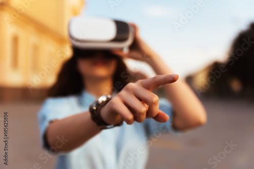 Young attractive happy woman excited using 3d goggles watching 360 virtual reality vision enjoying cyber fun experience in virtual reality