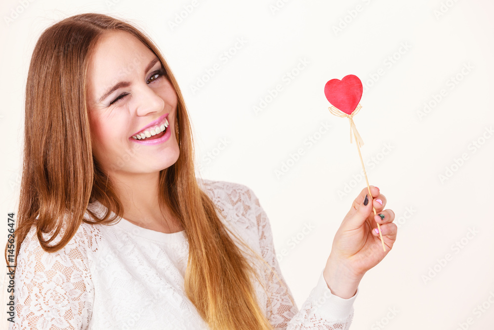 Beautiful woman holding heart shaped hand stick Beautiful woman holding heart shaped hand stick