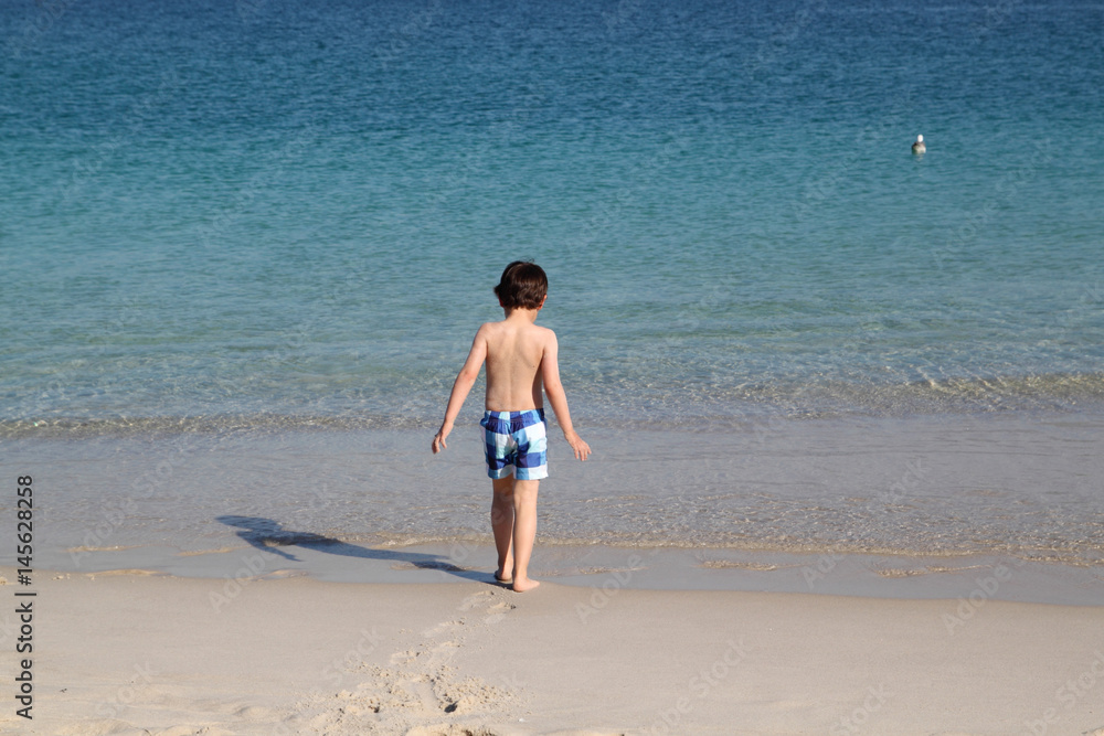 child walking in the beach