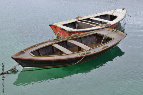 two wooden fishing boats on the water