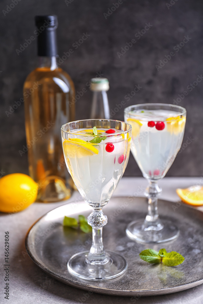 Refreshing cocktails with cranberry and lemon on table