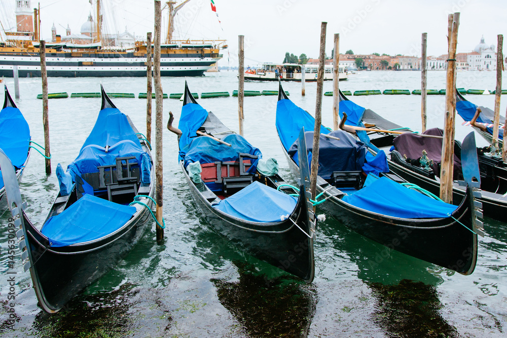 Moored gondolas to Venice, Italy, summer day.