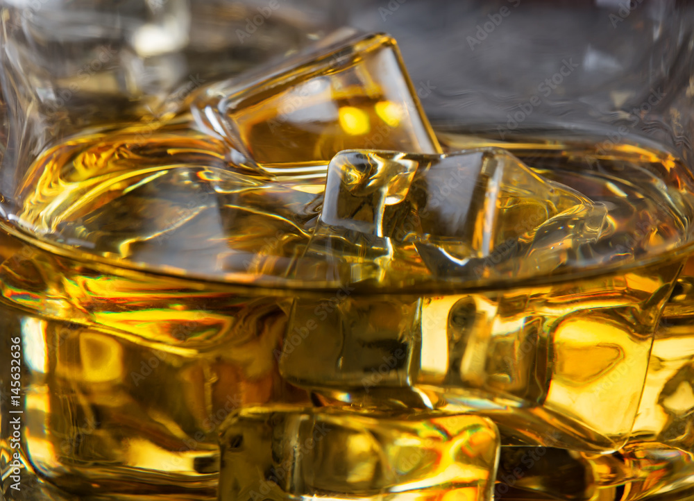 Ice in glass of whiskey macro Ice in glass of whiskey macro