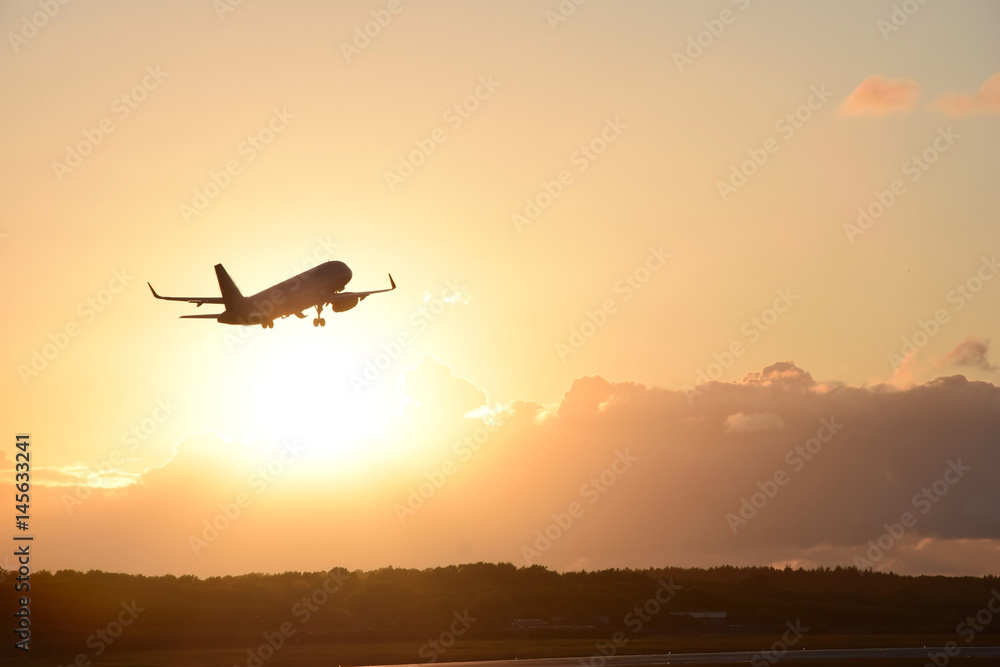 Plane take off with a sunset in the background Plane take off with a sunset in the background