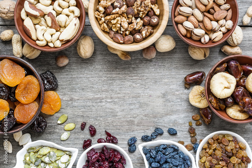 Mix of dried fruits and nuts on rustic wooden background