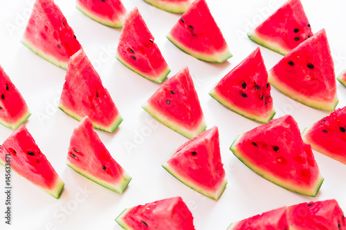 Slices of juicy watermelon on white background. Flat lay. Top view. Summer pattern