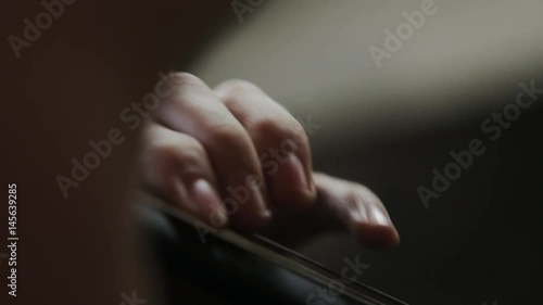 close up of fingers on string of cello