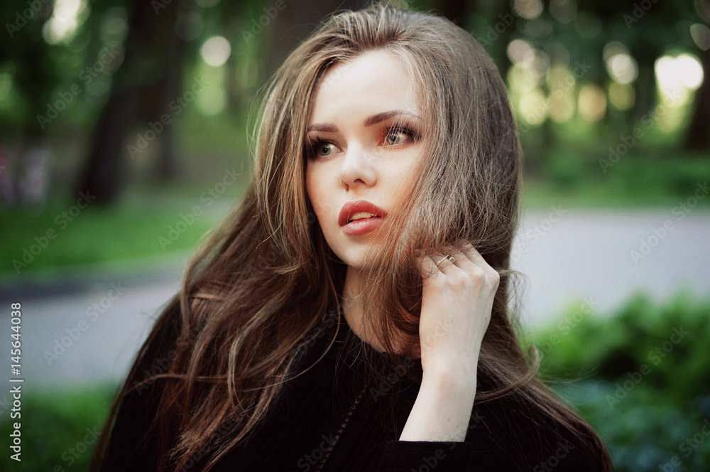 Naklejka premium Woman enjoying her time in Europe park with forest background