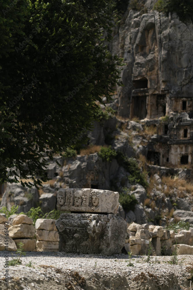 Ancient carved stone with three faces in Lycian Myra in Turkey