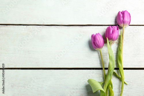 Fototapeta Naklejka Na Ścianę i Meble -  Beautiful lilac tulips on light wooden background