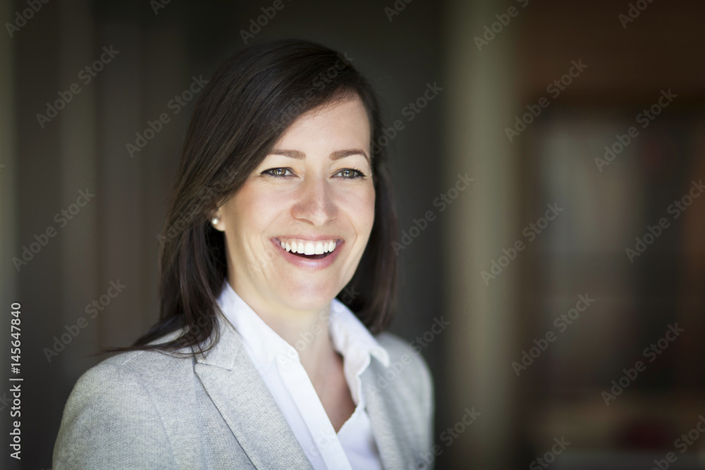 Mature Businesswoman Smiling At The Camera. Working At Home.