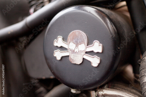 Metal skull with crossbones on motorcycle