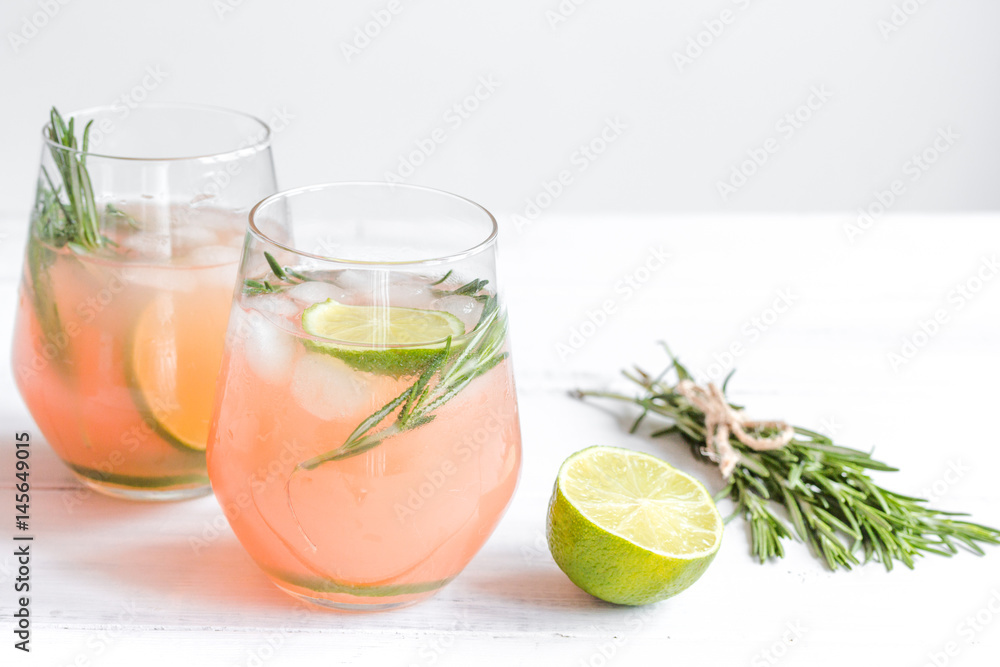 vegetable smoothie with lime and rosemary in glass on white table background vegetable smoothie with lime and rosemary in glass on white table background