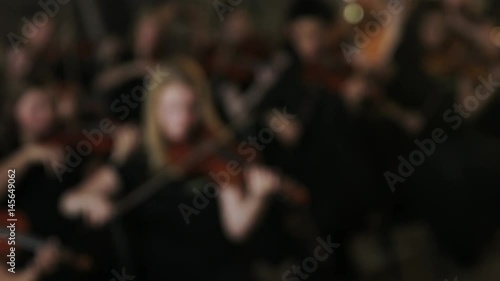 orchestra director directing group of kids