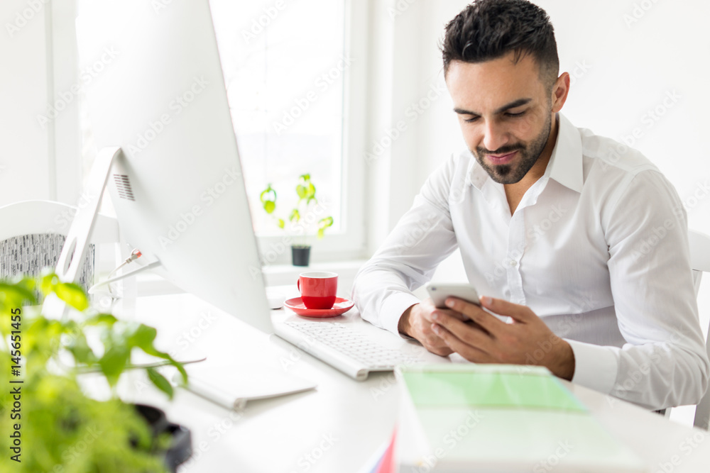 Young businessman working at office on computer desk Young businessman working at office on computer desk
