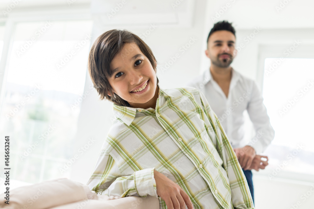 Fototapeta premium Happy Arabic Muslim family at modern home having fun and good time together