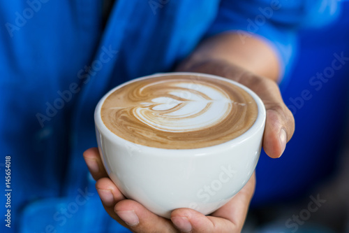 coffee latte art in hand barista