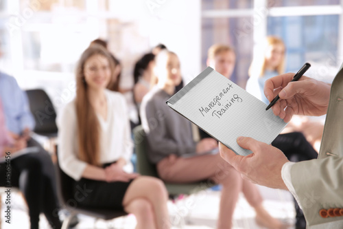 Business trainer holding no...