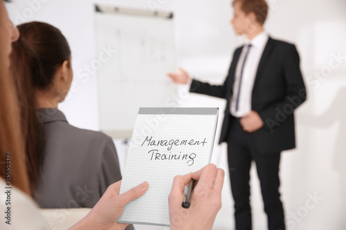 Woman holding notebook with...