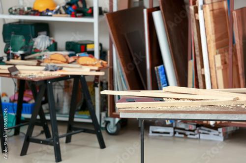 Table with wooden boards in carpenter's workshop © Africa Studio