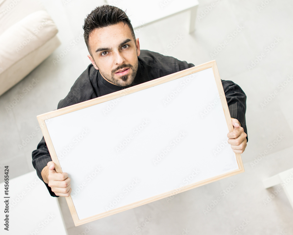 Attractive Arabic young man with white board for your message or text Attractive Arabic young man with white board for your message or text
