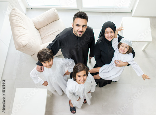 Photography High angle view portrait of happy Arabic Muslim family at new modern home
