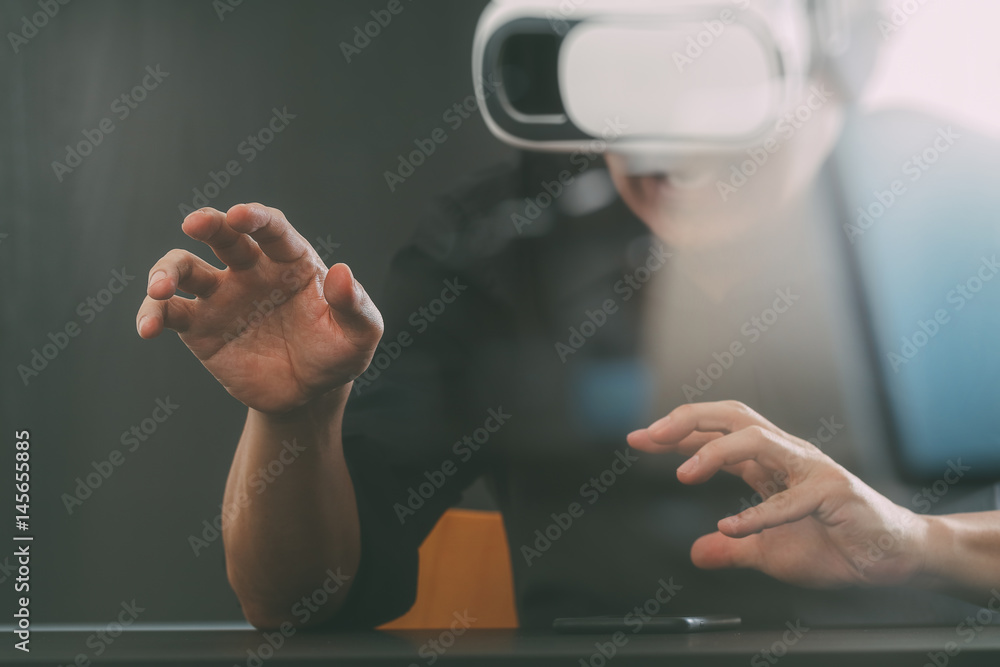businessman wearing virtual reality goggles in modern office with Smartphone using with VR headset