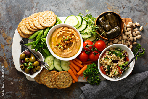 Photography Hummus and vegetables platter with grain salad