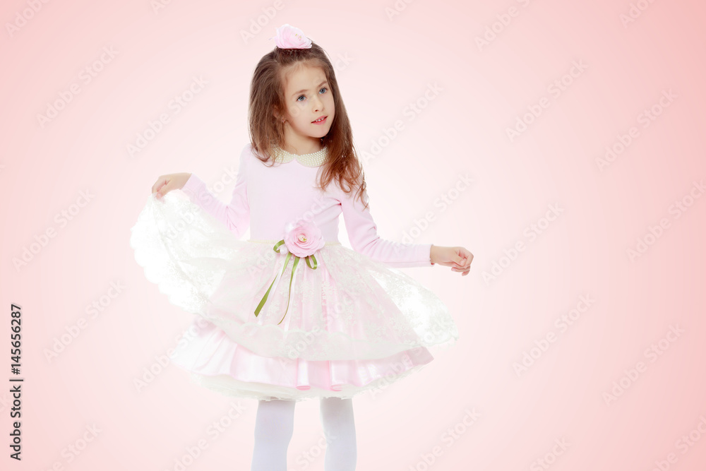 Elegant little girl in a pink dress. Elegant little girl in a pink dress.