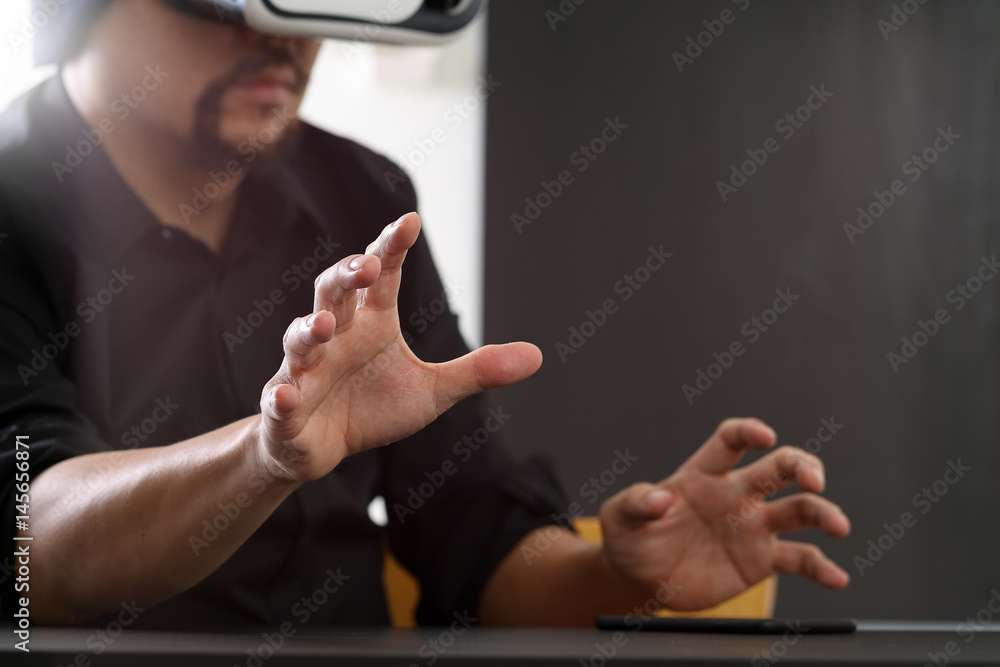 businessman wearing virtual reality goggles in modern office with Smartphone using with VR headset with screen icon diagram