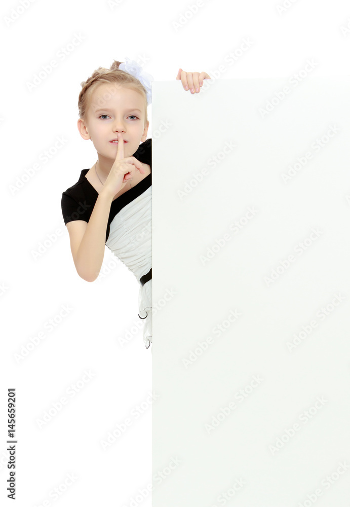 The girl peeks out from behind white banner. The girl peeks out from behind white banner.