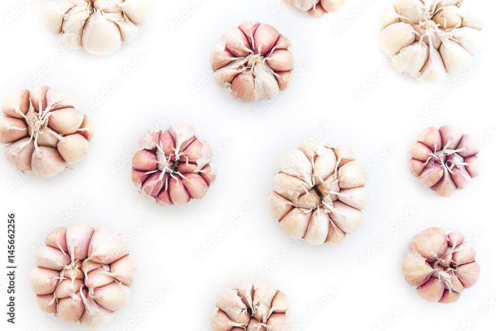 Top view of garlic bulb as pattern background on white Top view of garlic bulb as pattern background on white
