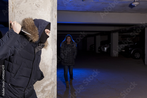 Criminal with knife waiting for a woman